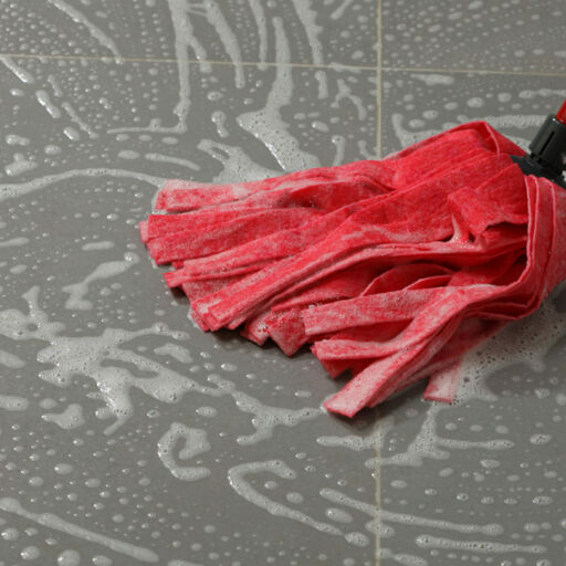 Mopping the floor tiles | Valley Floor Covering Inc